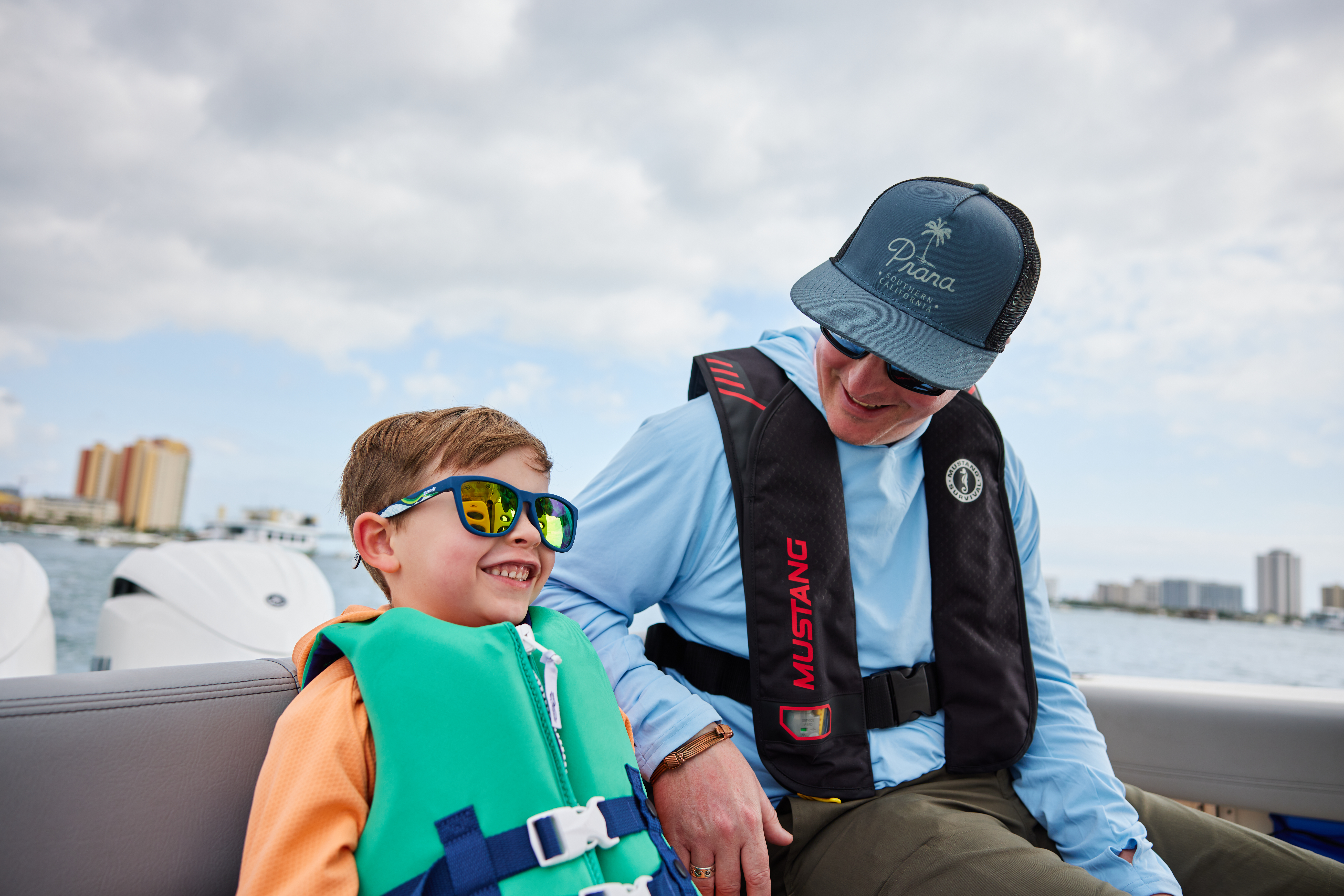  A man and a boy wearing lifejackets on a boat, Type 1 life jacket concept. 
