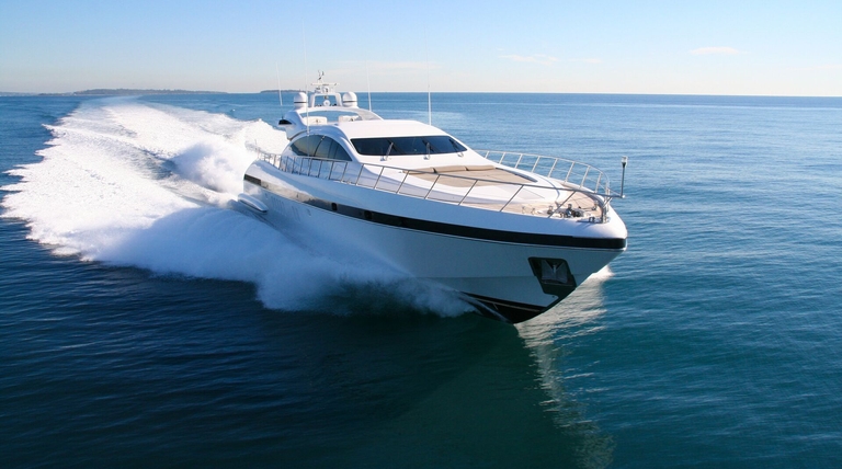 A yacht speeds across the water. 