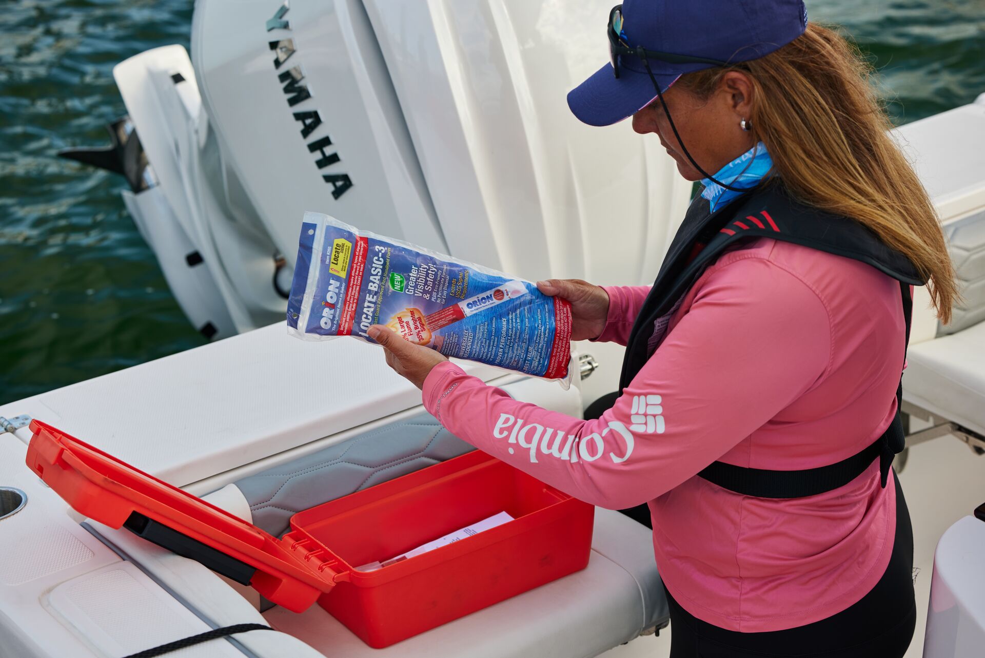 A woman checking safety equipment on a boat, renting a boat concept. 