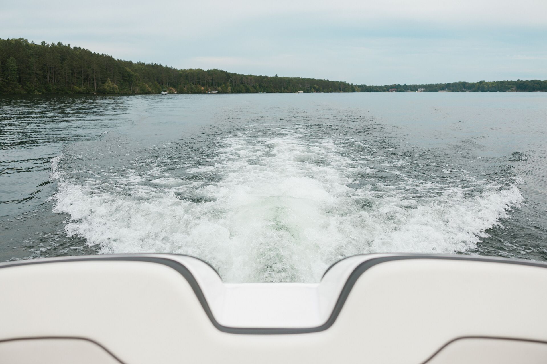 View off the backend of a boat seeing the wake, boat rentals near me concept. 