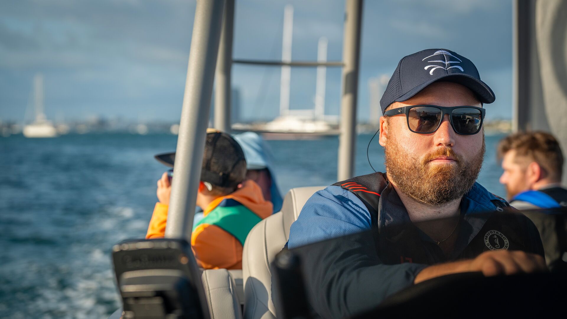 A man drives a boat with people on it, Father's Day gifts for boat owners concept. 