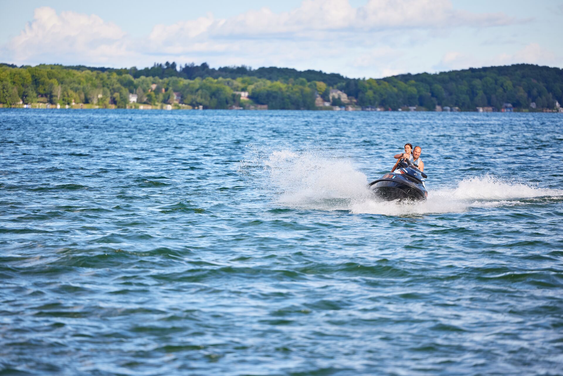 Two people on a jet ski in the distance. 