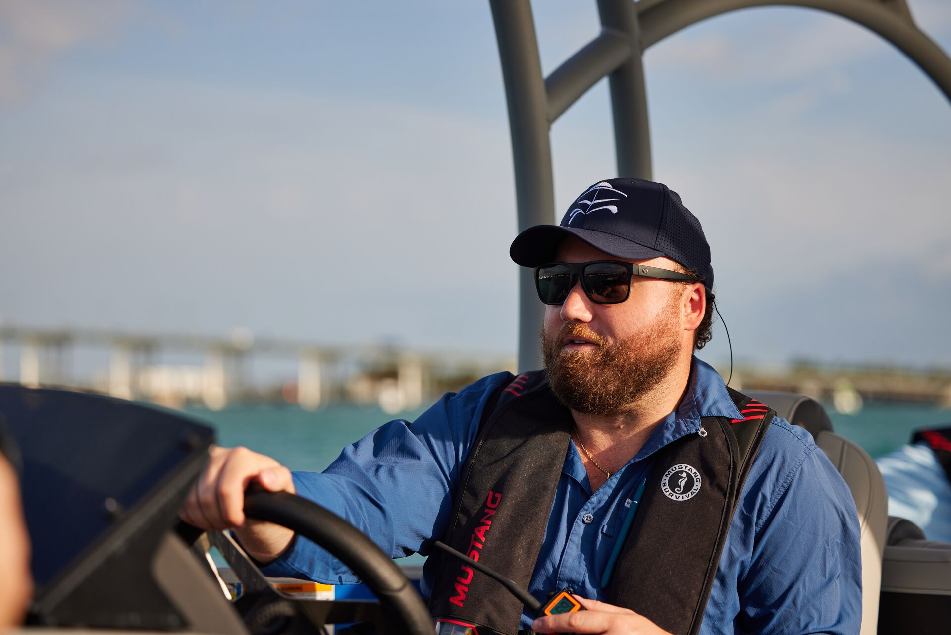 A man smiles while driving a boat, using boat lights concept. 