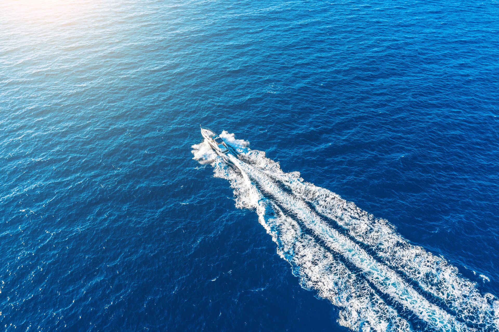 Overhead view of a jet boat going fast on the water. 