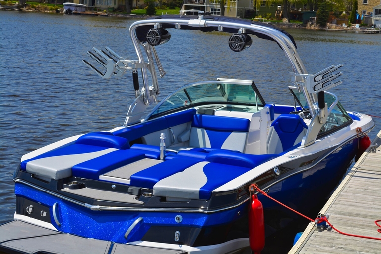 A jet boat tied at the dock. 