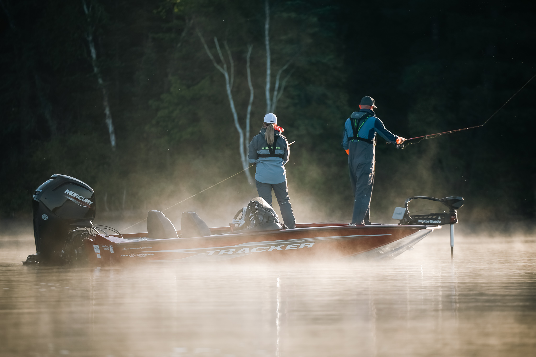 Two people on a fishing boat on the water in fog, catfishing fishing concept. 