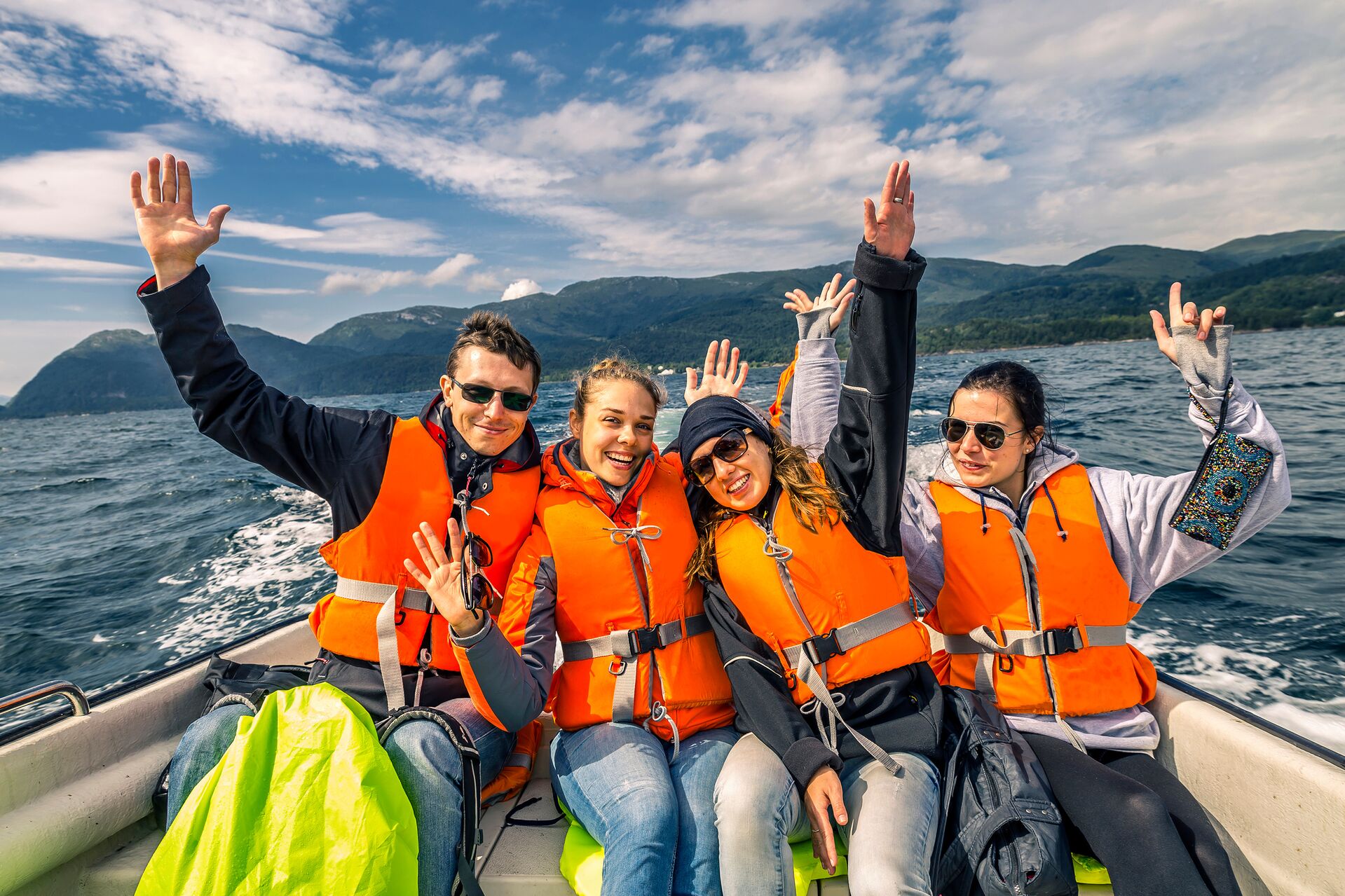 Adults wearing lifejackets in a boat, no boating under the inflluence concept. 