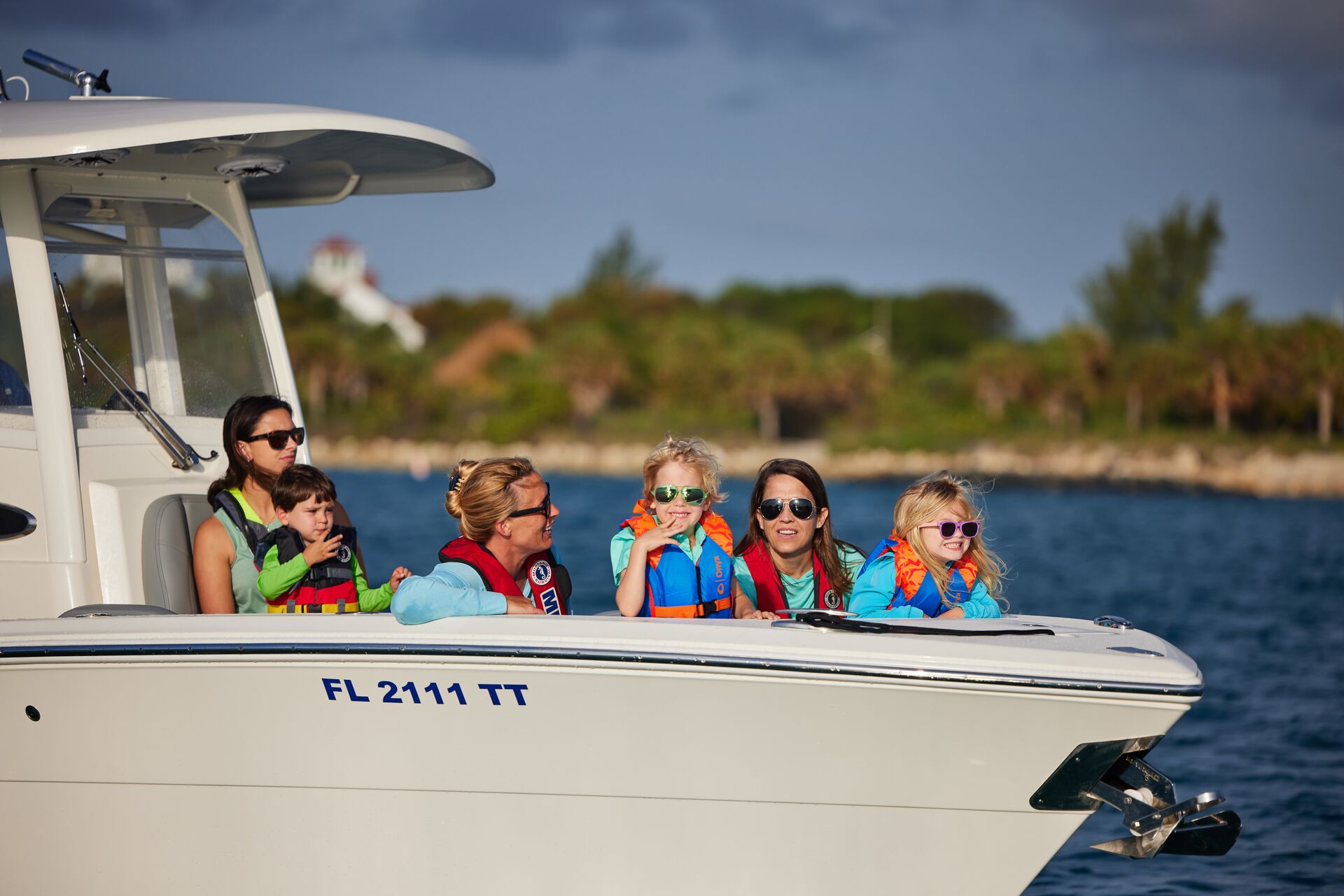 Several people on a boat wearing PFDs. 