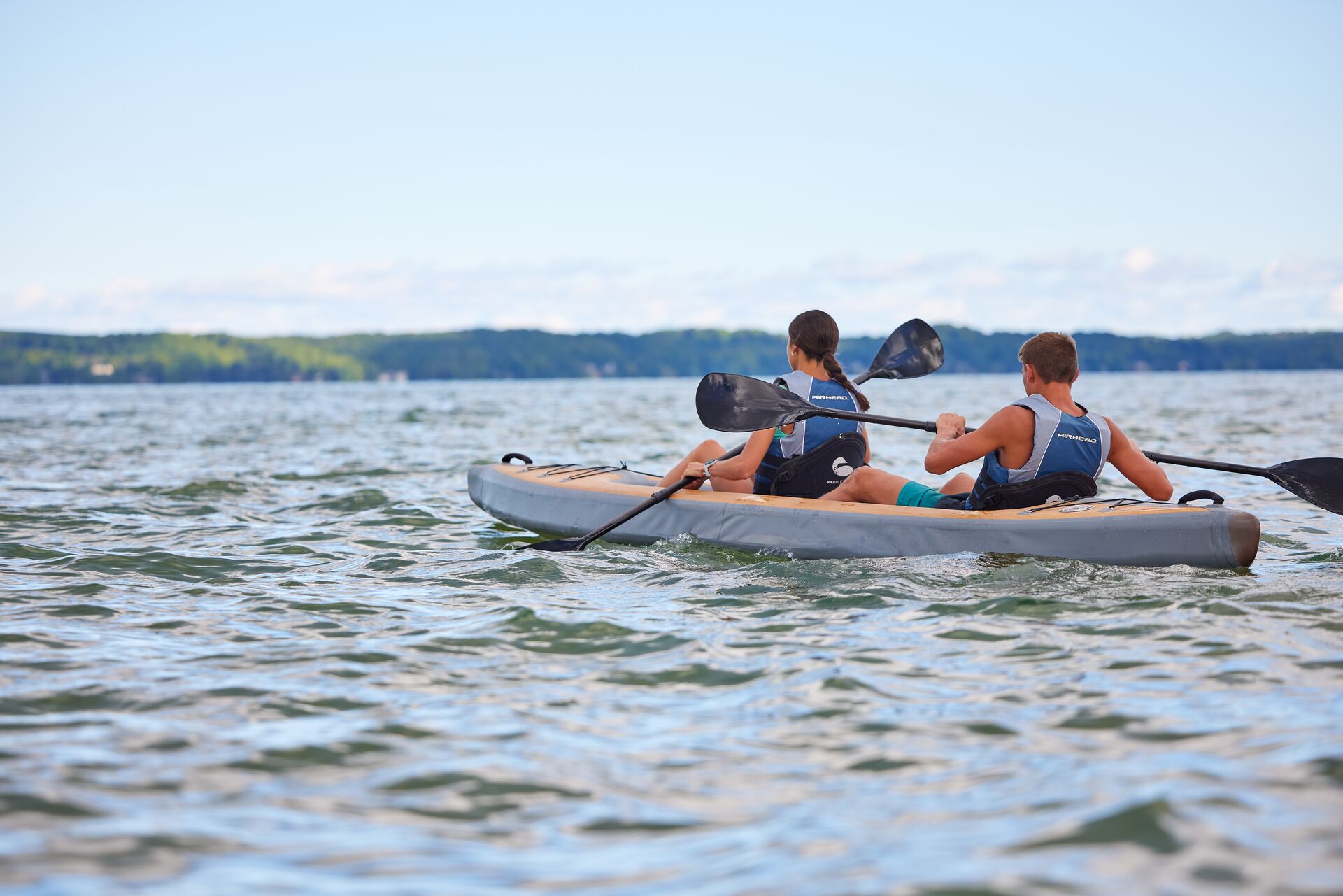 Two people paddling a kayak, boats likely to capsize concept. 