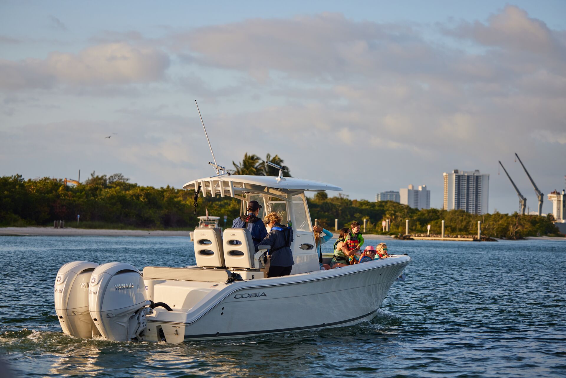 A fishing boat on the water near the coast. 