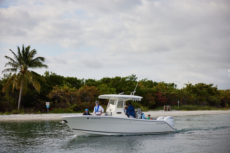 A bay boat on the water near shore. 