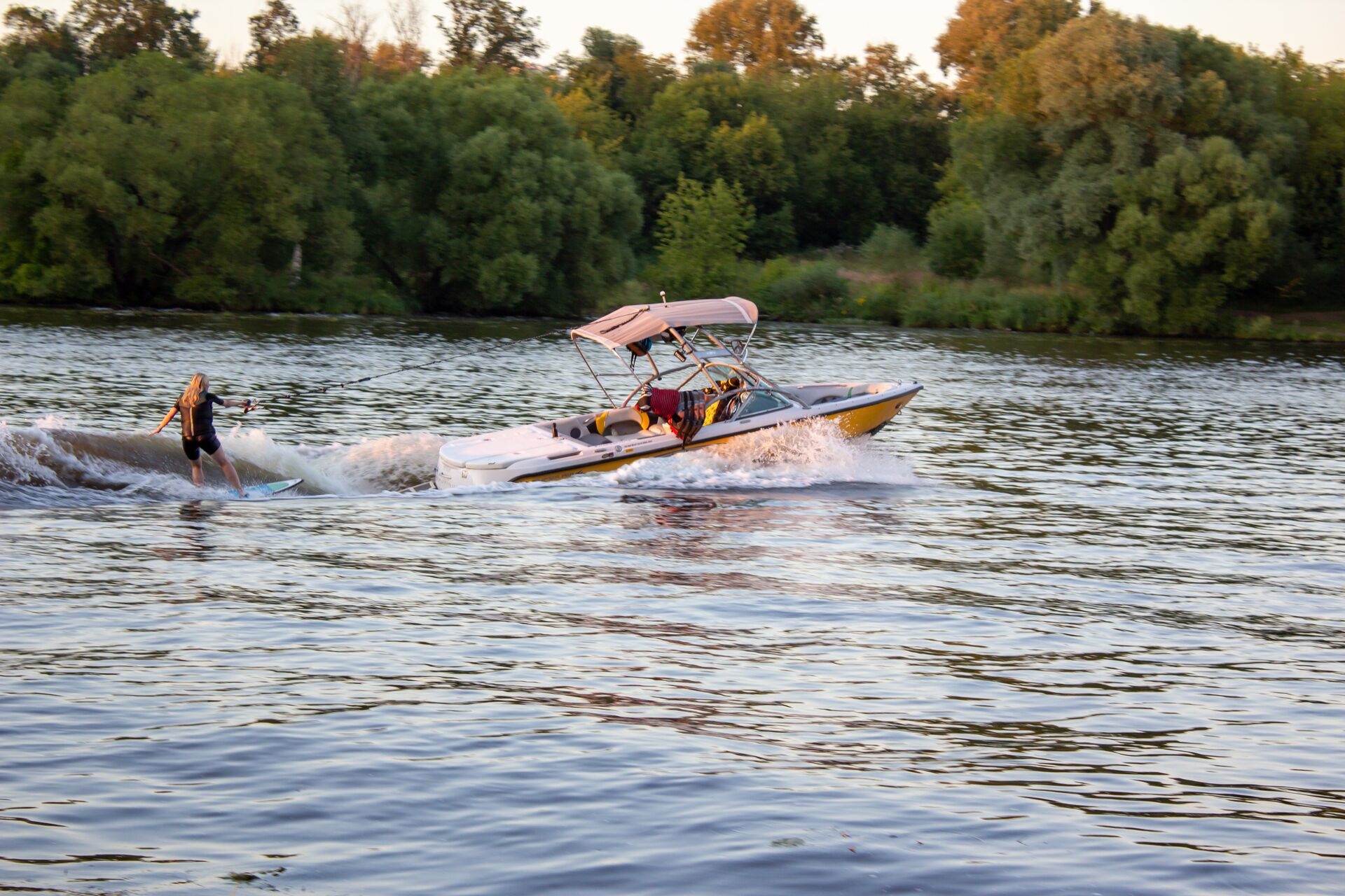 A person on water skis behind a boat on a lake. 