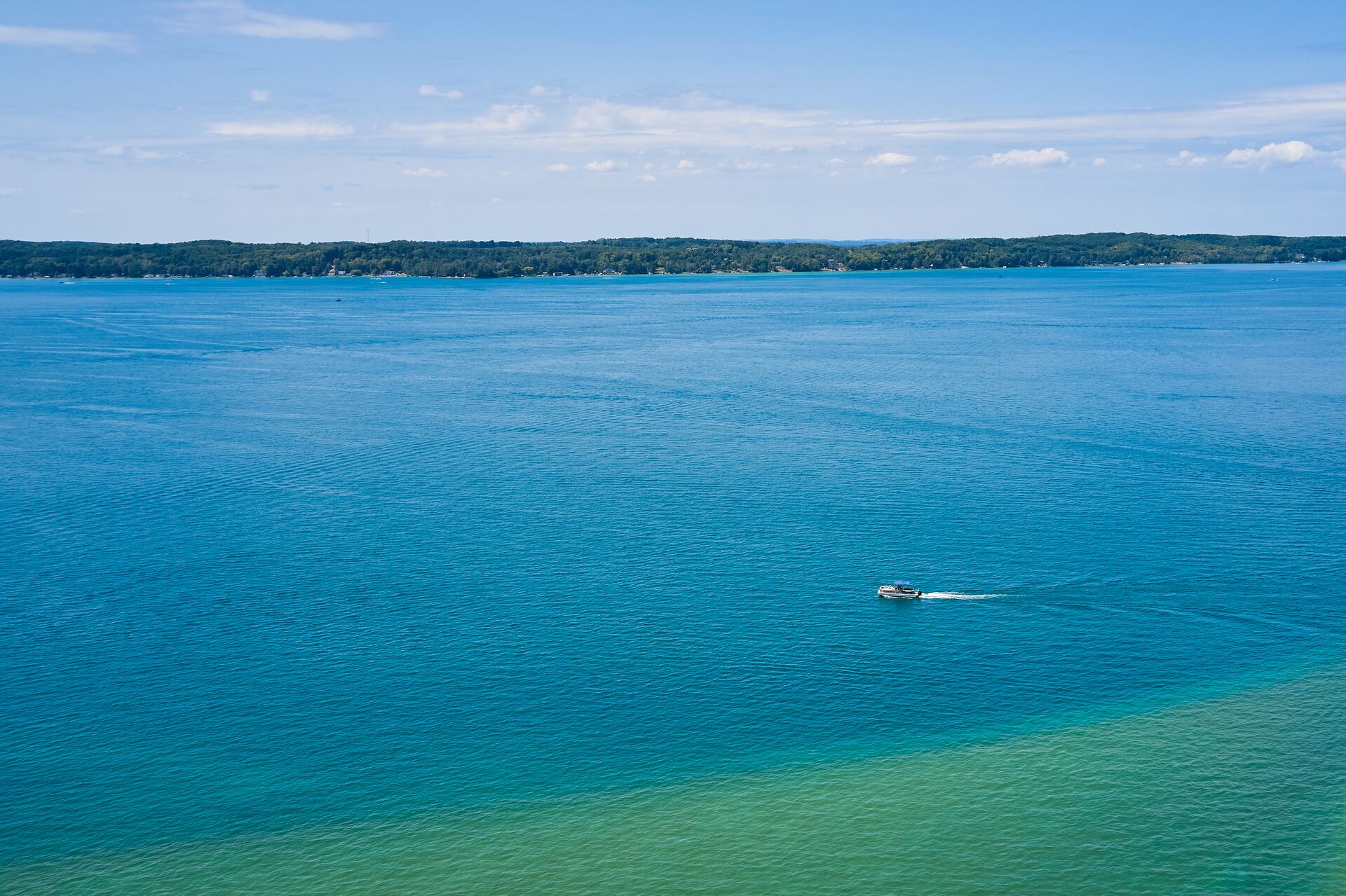 A boat in the distance on a lake, Wisconsin boat rentals concept.