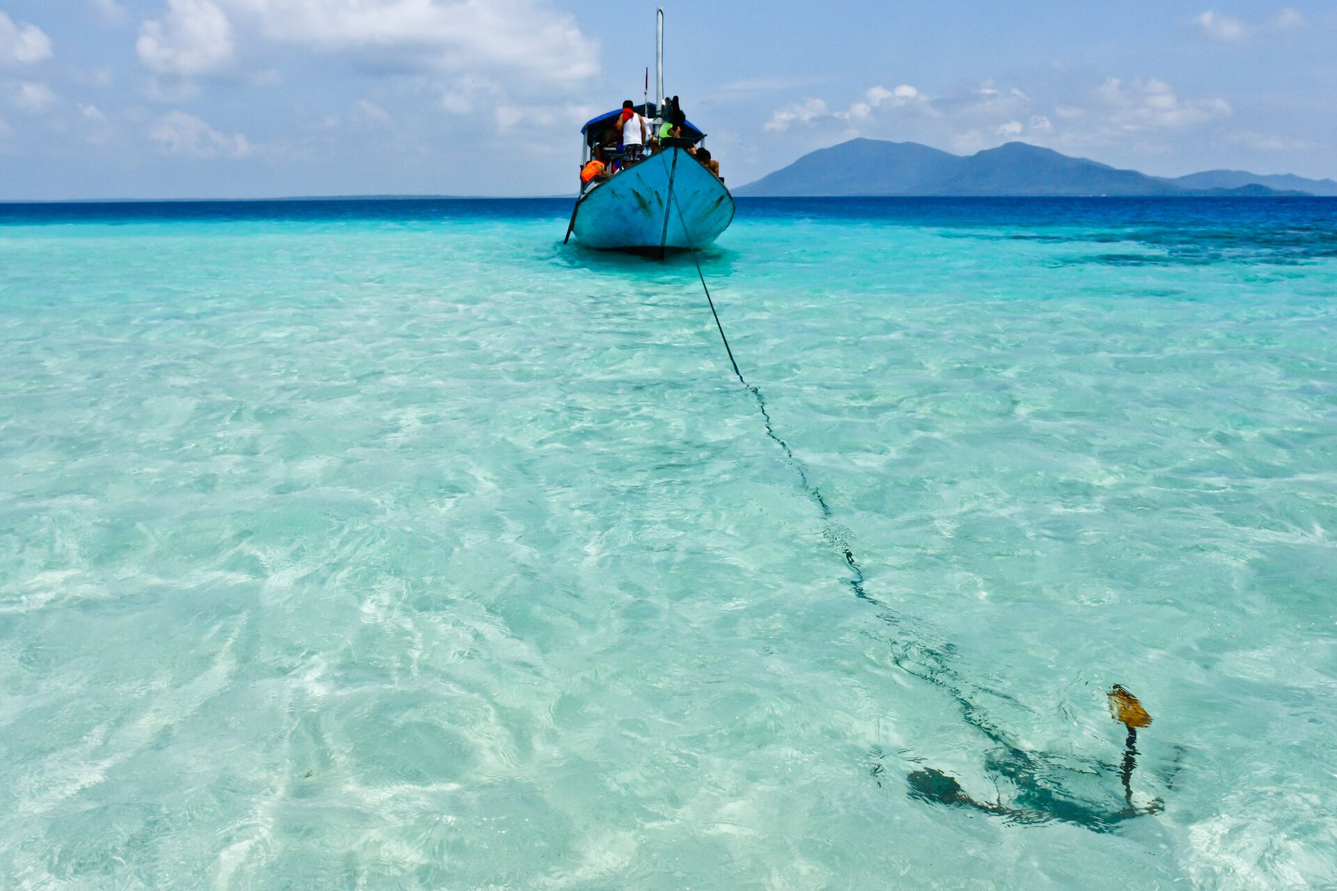 A boat anchored in shallow water. 